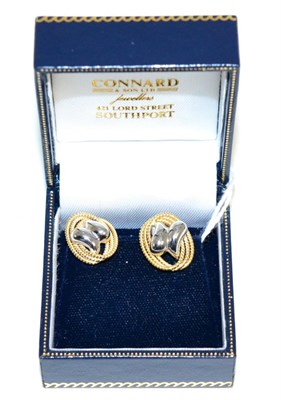 Lot 202 - A pair of 18 carat two colour gold earrings white gold scrolls within a yellow gold rope frame,...