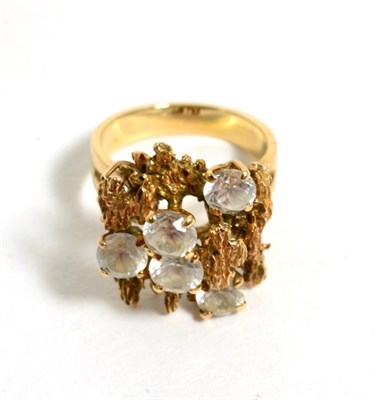 Lot 207 - A 1970s cubic zirconia cluster ring, round cut cubic zirconia to a textured bar top, finger...