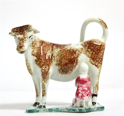 Lot 220 - A Pearlware cow creamer, circa 1820, the standing beast with brown sponged markings, a milkmaid...