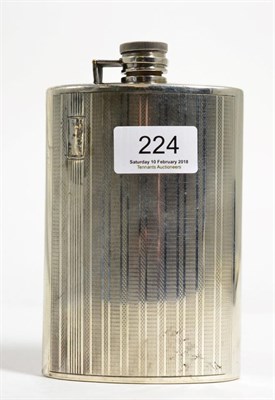 Lot 224 - A white metal hip flask, stamped 'Silver', of curved form with engine turned decoration, 15cm high