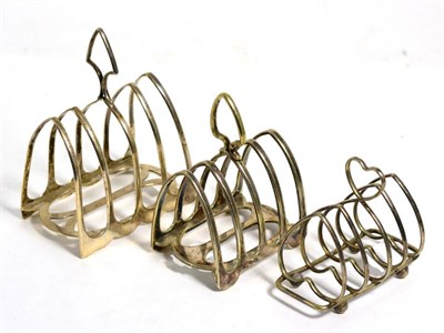 Lot 228 - William Hutton & Sons Ltd silver four division toast rack; and two silver plated toast racks (3)