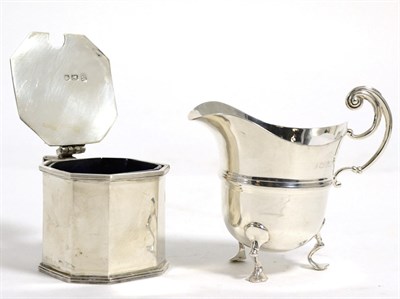 Lot 231 - A silver mustard with blue glass liner together with a silver helmet form cream jug (2)