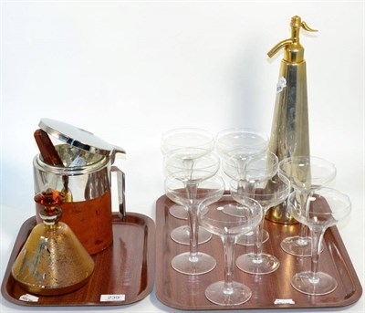 Lot 239 - A group of Art Deco style items comprising, a soda syphon, an ice bucket, liquor decanter and...