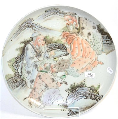 Lot 243 - A large Chinese porcelain shallow bowl, depicting four figures in a landscape