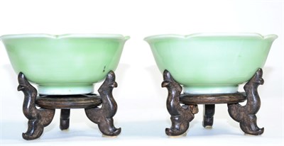 Lot 250 - A pair of Chinese celadon dishes, with wooden stands (2)