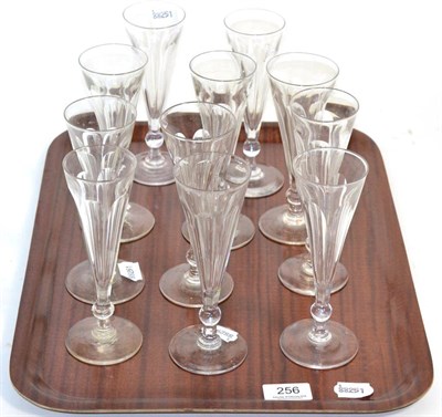 Lot 256 - A set of eleven champagne flutes with bell knop stems