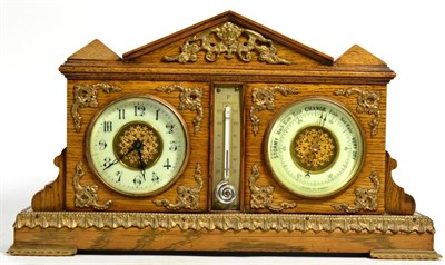 Lot 258 - An Edwardian gilt metal mounted oak cased combination clock, barometer and thermometer; the...