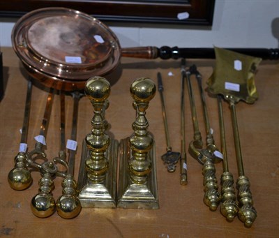 Lot 1099 - A pair of brass andirons, two sets of three fire tools and an additional two fire pokers and a...