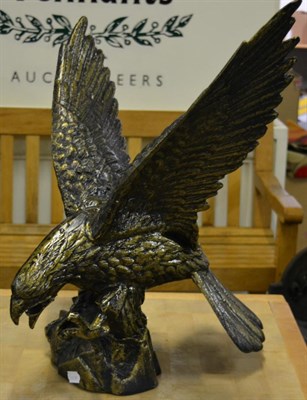 Lot 1107 - A patinated model of an eagle with wings outstretched