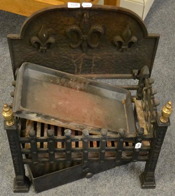 Lot 1126 - A cast iron fire grate with fleur-de-lis decorated back plate