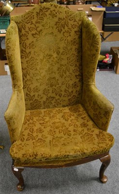 Lot 1135 - A George III style wing chair