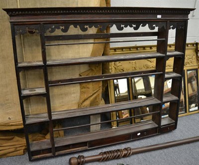 Lot 1139 - An 18th century dresser rack, with a dentil cornice above an arrangement of shelves and small...