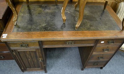 Lot 1146 - An Edwardian oak desk, early 20th century, with green leather top, with six drawers and a...