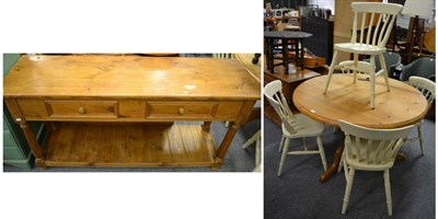 Lot 1150 - A pine two door dresser base, a pine breakfast table and a set of five white painted chairs (7)