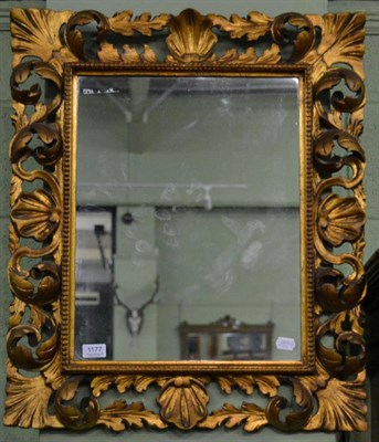 Lot 1177 - A gilt mirror within a beaded border with pierced acanthus scrolled and shell decorated frame, 71cm