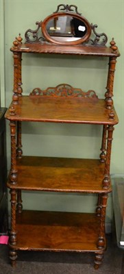 Lot 1181 - A Victorian walnut three tier etagere with mirrored surmount