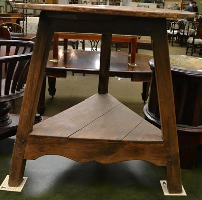 Lot 1203 - A 19th century pine cricket table with circular top and triangular shaped shelf