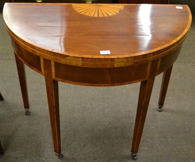 Lot 1228 - George III mahogany and inlaid semi-circular fold over games table