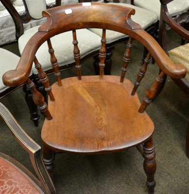 Lot 1239 - An early 20th century oak captain's chair