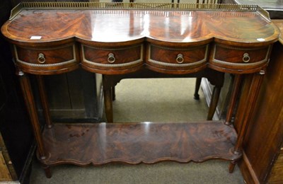 Lot 1267 - A flame mahogany two tier buffet with shaped top, pierced brass gallery and pot board stretcher