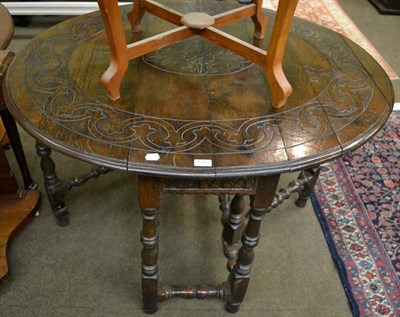 Lot 1275 - A carved gateleg table