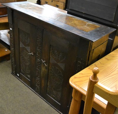 Lot 1278 - Carved oak cabinet enclosing two shelves