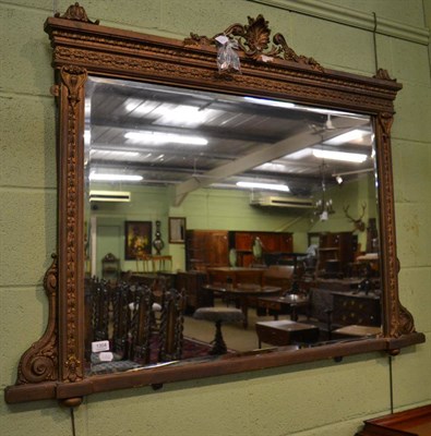 Lot 1304 - A gilt decorated over mantel mirror