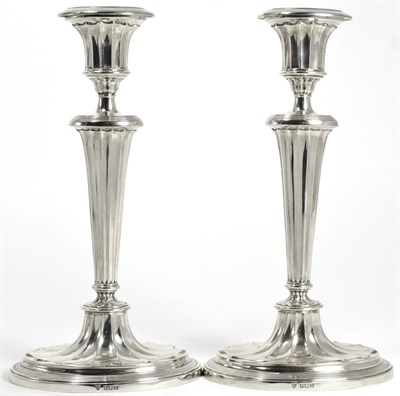 Lot 17 - A pair of silver candlesticks of George III style, Ellis & Co, Birmingham 1961, fluted and with...