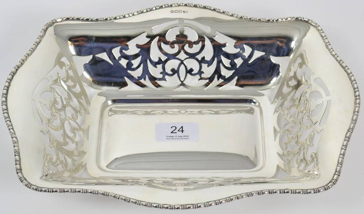 Lot 24 - A pierced silver basket, Viners Ltd, Sheffield 1938, shaped rectangular with scroll pierced...