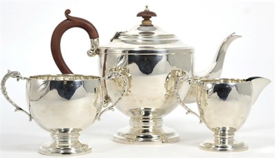 Lot 30 - A silver three piece tea service, maker indistinct, Birmingham 1943, the teapot 18cm high,...