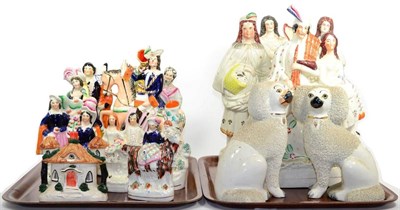 Lot 50 - A group of Staffordshire figures including a pair of dogs, flat back groups, etc, on two trays