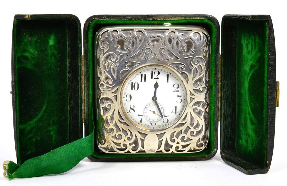 Lot 64 - A plated travelling watch in a silver mounted case, siver case stamped with maker's mark WC, in...