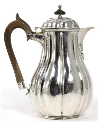 Lot 74 - A Victorian silver hot water jug, Lambert & Co, London 1890, baluster fluted form, 18cm high,...