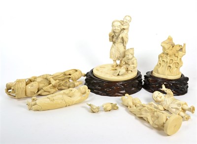 Lot 83 - A collection of four Japanese ivory okimonos, two with wood bases (all a.f.)