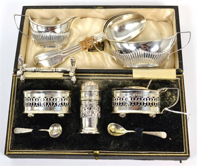 Lot 84 - A silver three piece condiment set, Barker Bros, Birmingham 1932, in a fitted case; and a cream jug