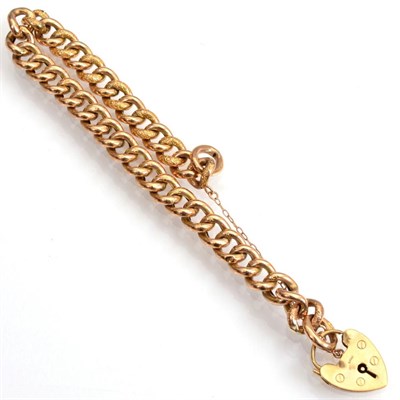 Lot 111 - A chased curb link bracelet, with a 9 carat gold padlock claps, length 21cm
