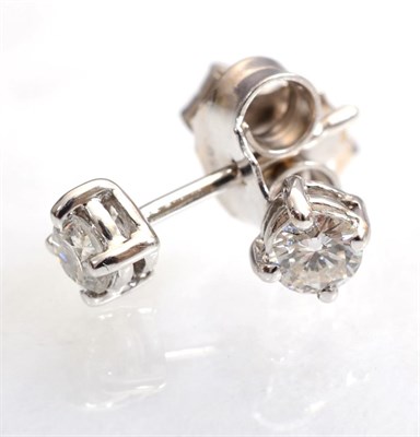 Lot 119 - A pair of 18 carat white gold solitaire diamond earrings, round brilliant cut diamonds in four claw