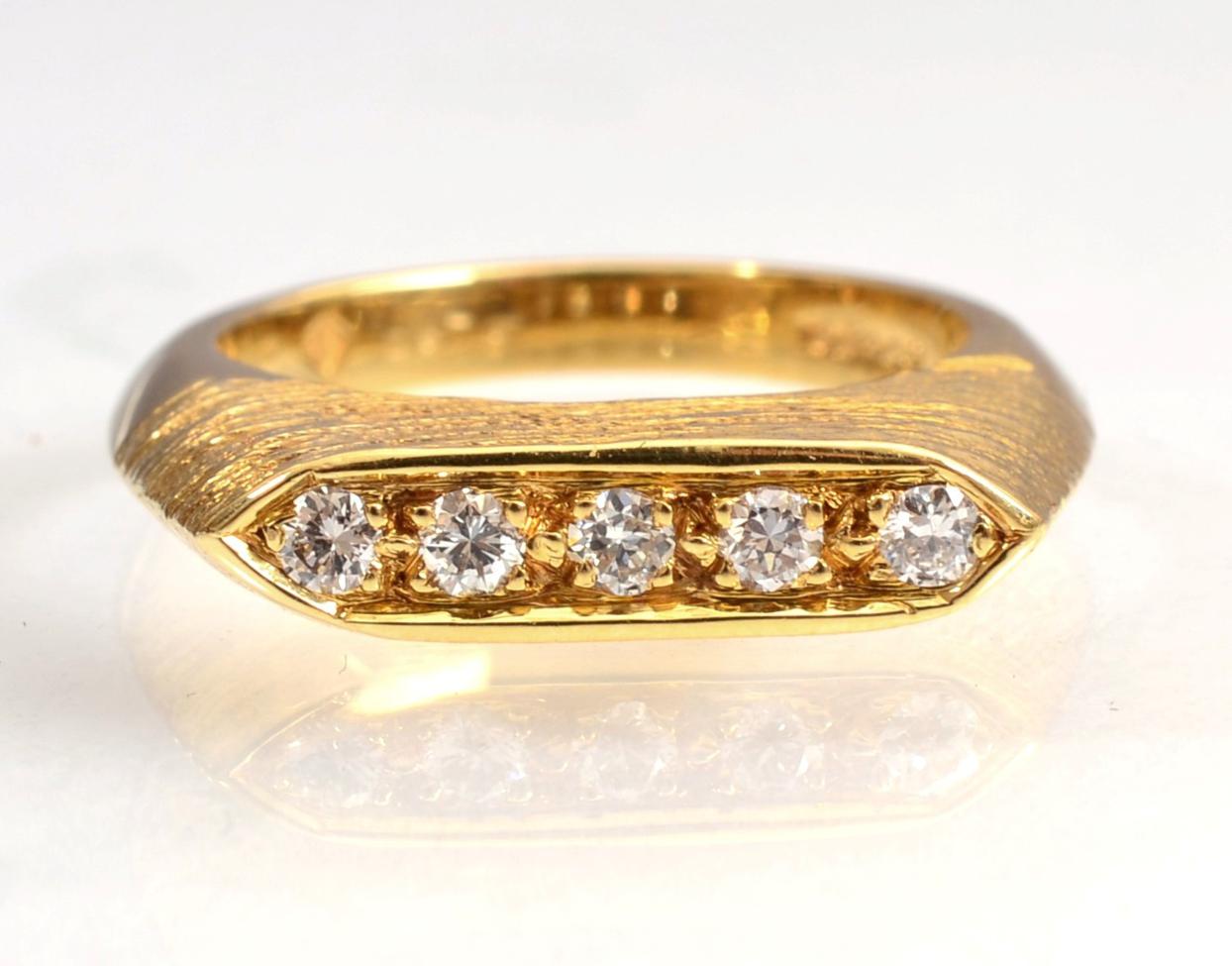 Lot 136 - An 18 carat gold diamond ring, five round brilliant cut diamonds inset to a tapering textured...