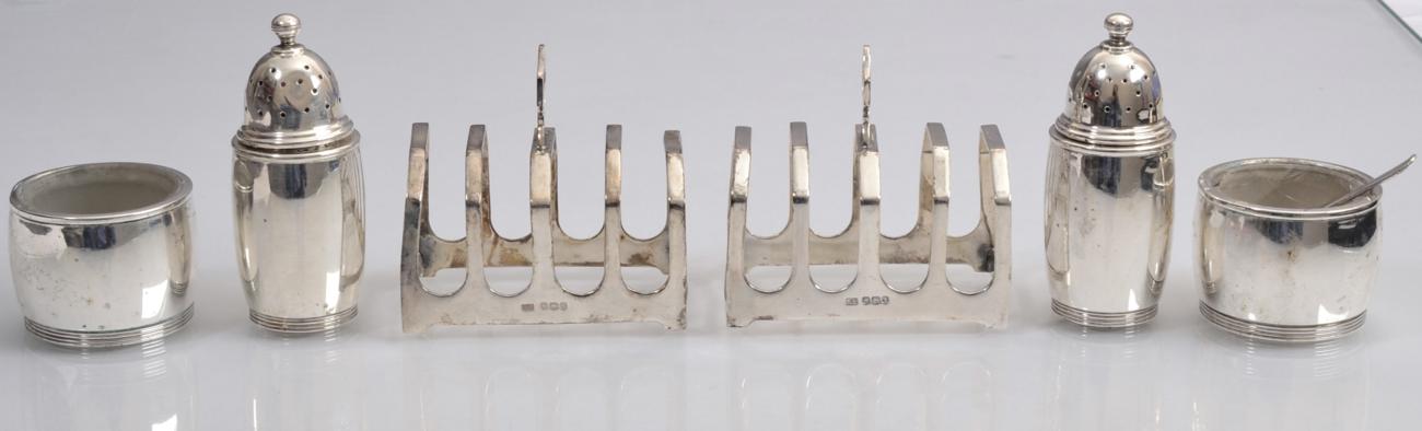 Lot 143 - A pair of silver toast racks, Viners Ltd, Sheffield 1933; and a four piece salt and pepper set,...