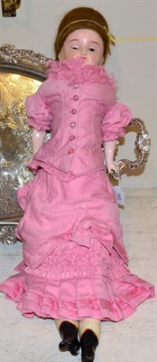 Lot 160 - 19th century wax shoulder head doll, with brown stylised wig, sleeping blue eyes, fabric body...
