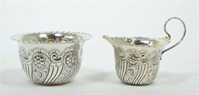 Lot 260 - A late Victorian silver cream jug and sugar bowl, Thomas Henry Blake, Sheffield 1897, engraved with
