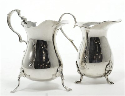 Lot 313 - Two 18th century style silver cream jugs, Birmingham 1964 and 1970, the larger 10cm high,...