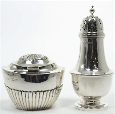 Lot 316 - A silver caster, George Unite, Birmingham 1921, plain with pull off cover; and a silver caddy...