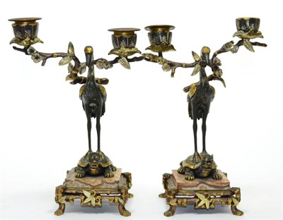 Lot 317 - A pair of Japanese bronze twin-light candle holders in the form of cranes