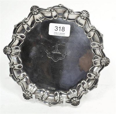 Lot 318 - A silver salver engraved with a family crest, Sheffield hallmark, makers mark HW