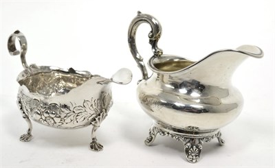 Lot 321 - An early Victorian silver cream jug, London 1844 cream jug; and a George II silver sauce boat...