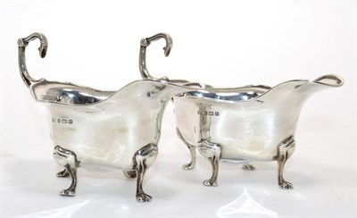 Lot 324 - A pair of Edwardian silver sauce boats, Deakin & Francis, Birmingham 1904, shaped oval form...