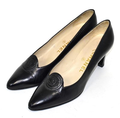 Lot 329 - Pair of Chanel black leather heeled court shoes, with interlocking 'CC' motif within a stitched...