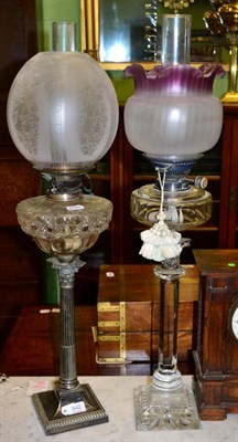 Lot 340 - A silver plated Corinthian column cut glass oil lamp and another Corinthian column glass oil...