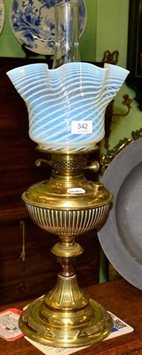 Lot 342 - A brass oil lamp with vaseline shade